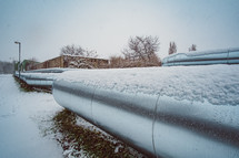 snow on metal pipes 