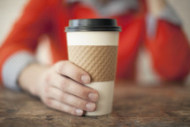 a man holding a coffee cup 
