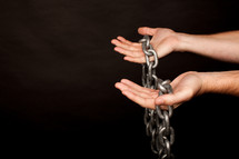 hands holding a chain 