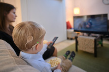 a child with cochlear implants watching TV 