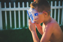 a little boy with snorkel and googles 