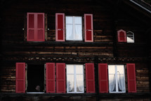 red shutters on a window 