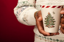 a man holding a Christmas mug 