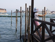 a woman taking a selfie on a dock in Venice 