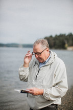 a pastor praying outdoors before a Baptism 
