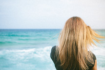 woman's hair blowing in the ocean breeze 