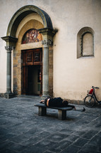 homeless sleeping on a bench 