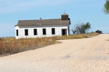 a small abandoned church and gravel road 