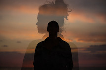 silhouettes of a man and woman at sunset 