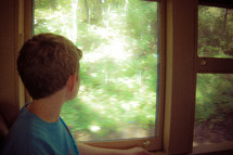 a boy looking out of a window 