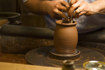man using a pottery wheel 