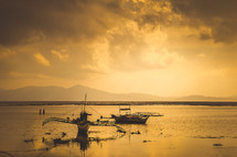 shrimp and fishing boats on the water at sunrise 