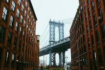 brick buildings and view of a bridge in NYC 