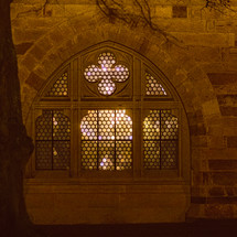 stone church window exterior at night 