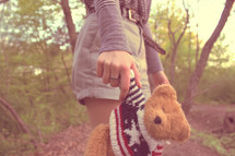 hand holding a teddy bear