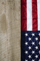 American flag hanging on wood.