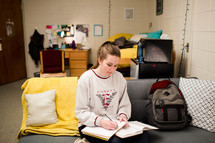 college student studying in her dorm room 
