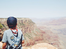 child looking out at the vastness of the Grand Canyon 