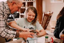 Grandfather and granddaughter baking Christmas cookies
