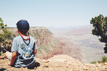 a child looking out at the vastness of the Grand Canyon 