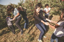 family dancing in an apple orchard 