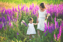 sisters playing in a field of flowers 