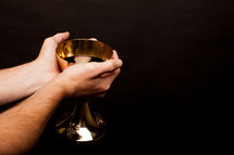 priest blessing the wine chalice 