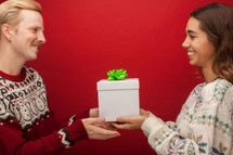 a couple giving Christmas presents 