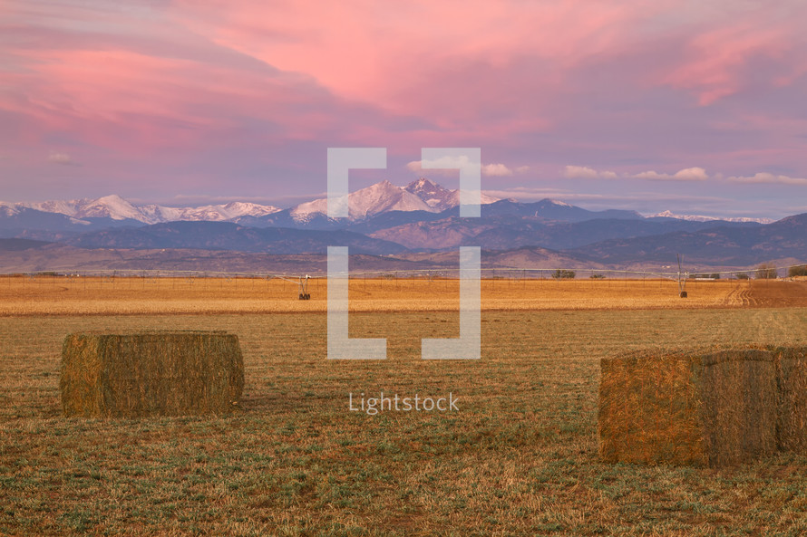 hay bales with distant snow capped mountains 