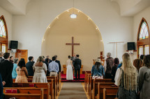 Wedding ceremony inside a small church.