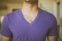 man's chest and cross necklace 
