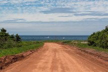 dirt road leading to a beach 
