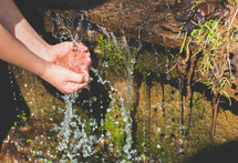 washing hands in a stream 