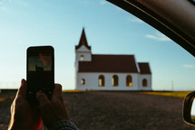 taking a picture with a cellphone of a rural church 
