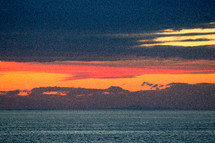 vibrant orange sky at sunset over the ocean 