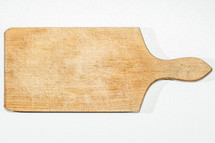 A cutting board on a white countertop.