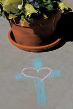 cross and heart in sidewalk chalk and potted pansies 
