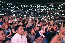 cellphone lights in a crowd at a concert 