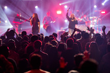worship leaders on stage singing during a worship service 