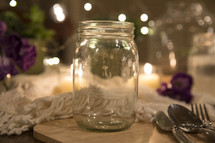 mason jar glass and silverware on a table 