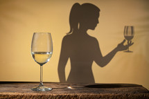 Abstract Woman shadow with Wine Glass and White Wine Glass