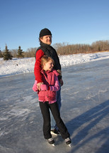 a young daughter and dad skating together