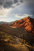 red rock mountains and fence 