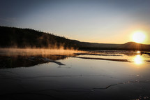 steam rising over a lake 