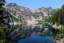reflections of mountain peaks on a lake 