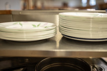 stack of dishes at a cafeteria