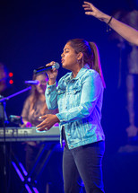 young woman singing on stage 