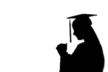 silhouette of a graduate in prayer 