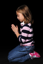 girl child kneeling in prayer 