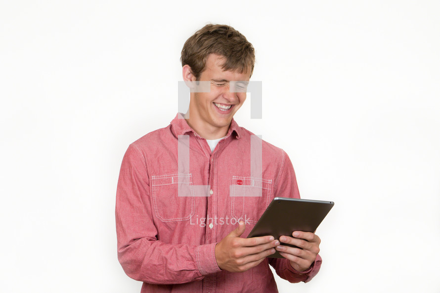Laughing man holding a book.